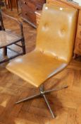 A pair of 20th century button leather swivel chairs, on chromed steel pedestal splayed legs,