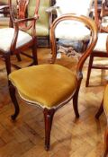 A set of three Victorian rosewood balloon back dining chairs, with foliate carved splats,