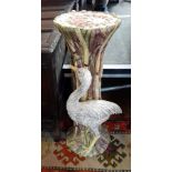 A decorative ceramic jardiniere stand with floral and bird decoration,