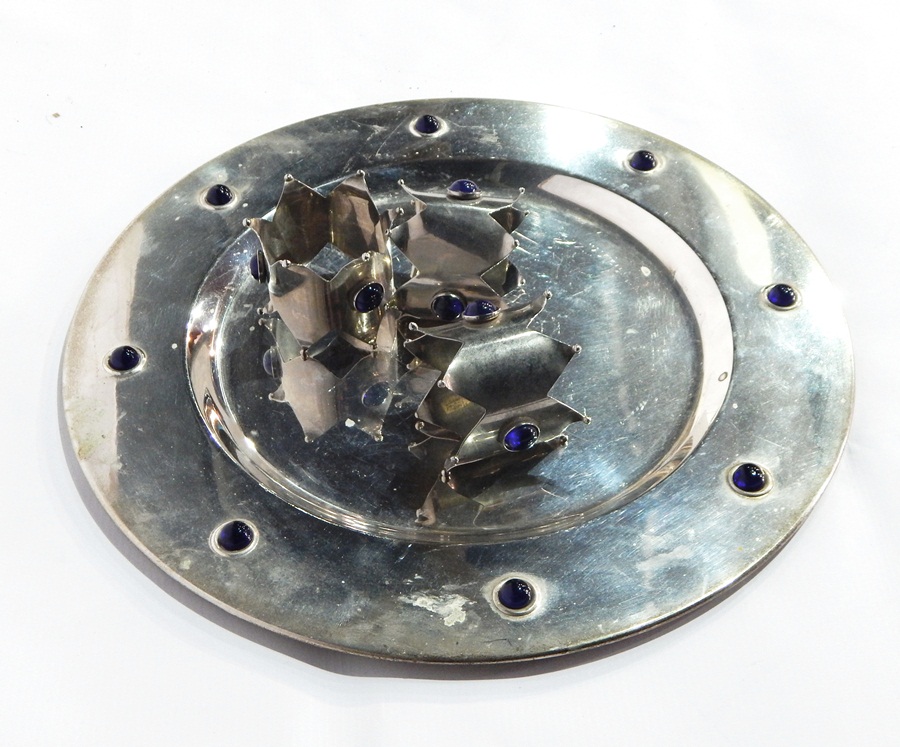 Set of six white metal circular platter table mats inlaid with blue stones and matching napkin ring