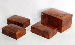 A Moroccan thuya wood box with fitted interior and three others with domed tops (4)