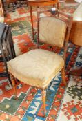 A pair of late Victorian walnut dining chairs with upholstered panelled backs, stuffover seats,