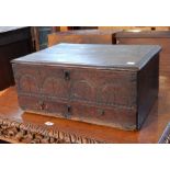 An 18th century carved oak bible box with moulded edge top and arcaded carving to front with long