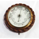 A carved oak aneroid barometer of ropetwist design, cased, white enamel dial, inscribed "Davis,