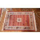 A Persian style prayer mat with red ground, geometric decoration,