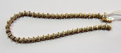 Gold coloured metal and diamond bracelet,