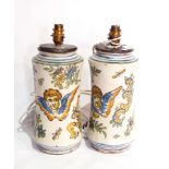 A pair of continental maiolica table lamps of waisted form, depicting cherubs and flowers,