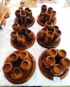 A quantity of Moroccan decorative thuya wood graduated tealight holders on circular trays