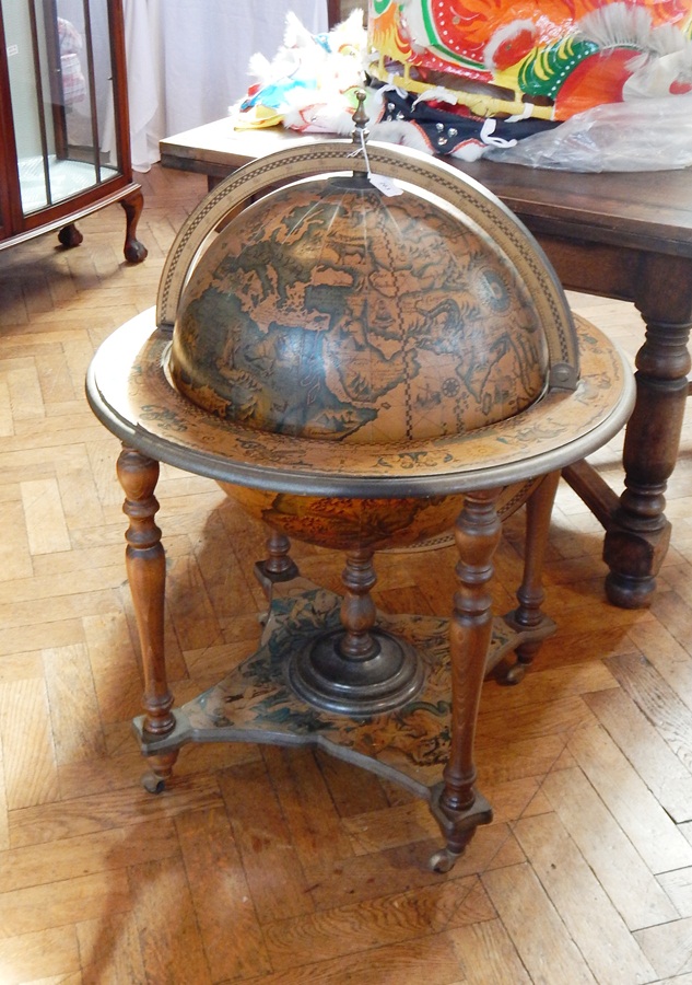 A cocktail cabinet in the form of a terrestrial globe on a stand,
