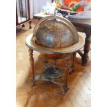 A cocktail cabinet in the form of a terrestrial globe on a stand,