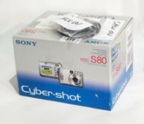 A Sony Cybershot DSCS80 digital camera with cable,