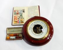 An aneroid barometer, a viewing magnifier, a small quantity of stamps,