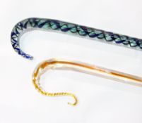 Aqua glass walking stick with blue and black spirally twisted interior and an ochre and clear glass