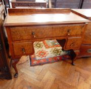 A Queen Anne style walnut veneer dressing table, with bevel edge top,