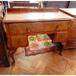 A Queen Anne style walnut veneer dressing table, with bevel edge top,