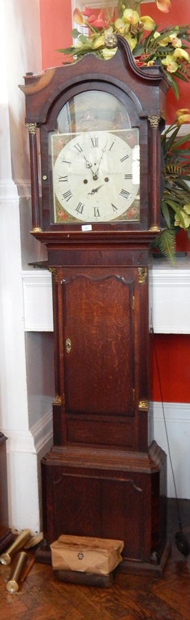 An early 19th century oak longcase clock, with swan neck pediment,