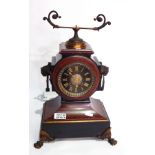 A Victorian red and black marble mantel clock, with ring handles and paw feet,