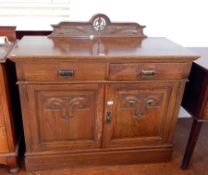 An early Victorian oak sideboard with art nouveau style carving,