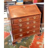 A George III mahogany bureau, with cheviot wood crossbanding,