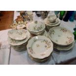 A Limoges part dinner service comprising dinner plates, bowls, serving dishes, a covered tureen,