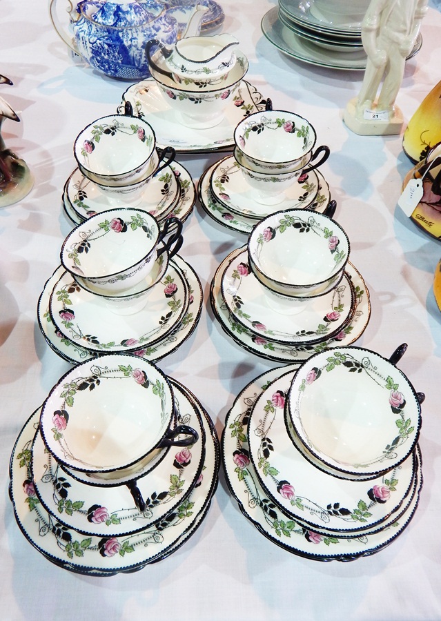 Shelley china teaset for eight persons with trailing rose borders, in pink, green and black,