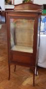 An Edwardian mahogany display cabinet, the glazed panel door with glazed sides to enclose shelves,