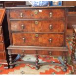 An 18th century oak and walnut chest on stand with moulded edge top, three long graduated drawers,