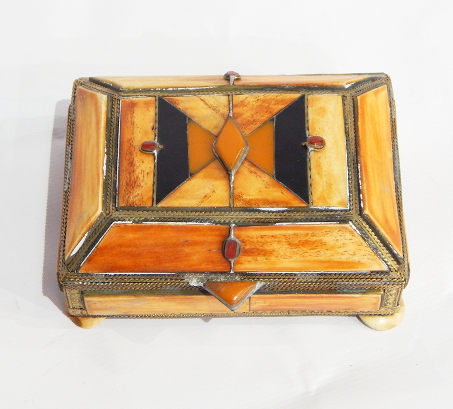 A collection of five Moroccan stained bone and polished stone inset caskets with brass mounts,