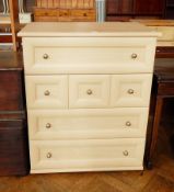 A modern chest of four drawers with ball handles,