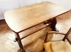 An oak refectory style dining table on trestle supports and plinth feet,