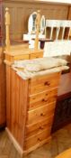 A chest of five drawers with matching toilet mirror