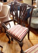 Four matching dining chairs with red and white patterned cushions,