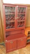 A contemporary glazed display cabinet with a pair of cupboards below on a plinth base, width 90 cm,