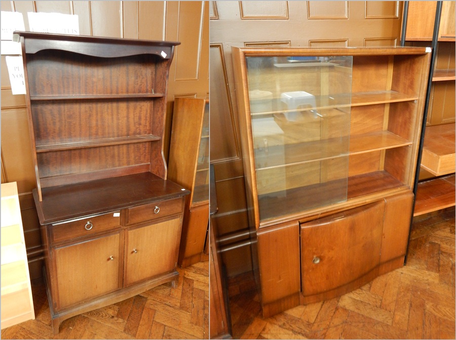 A 20th century bookcase with glass sliding doors, and bow front cupboard below,