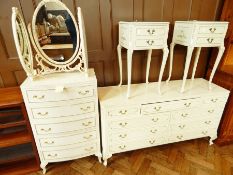 A white painted bedroom suite comprising a triple frame mirror, bow front chest of five drawers,