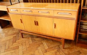 A G-Plan sideboard with three frieze drawers and three cupboards below,