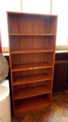 A contemporary open bookcase of six shelves,