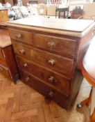 A Victorian grained pine chest of two short and two long graduated drawers, with bun handles,