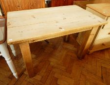 A pine kitchen table on large square baluster legs,