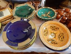 A quantity of Moroccan brightly glazed and silver-coloured metal mounted large bowls,