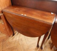 An oak drop-leaf table and a pair of oak bedside cabinets