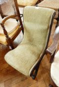 An oak child's chair with green weave fabric