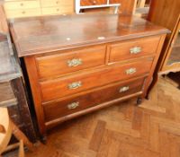 A walnut chest of two short and two long drawers with brass serpentine handles,