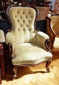 A Victorian mahogany cream button backed armchair on cabriole legs