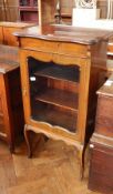 A stained wood display cabinet with two shelves and glazed doors, on cabriole legs,