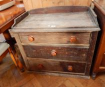 A pine chest of three graduating drawers, bun handles,