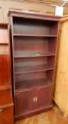 A modern open bookcase with dentil frieze,