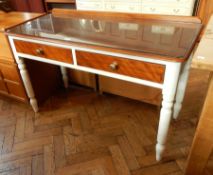 A sideboard with two short drawers and white painted legs,