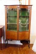 An Edwardian mahogany serpentine front display cabinet,