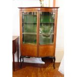 An Edwardian mahogany serpentine front display cabinet,